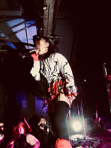 Emei performs onstage. 